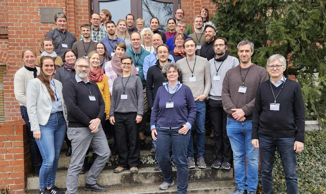 a group of persons front to a biulding